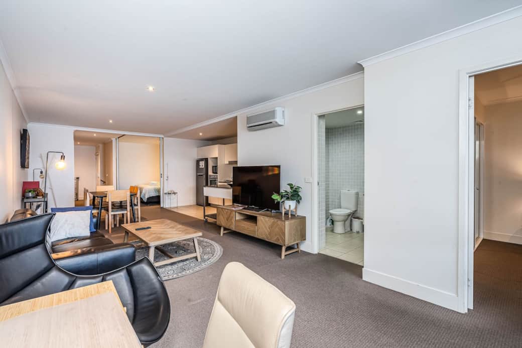 Welcome to your living room, where comfort meets style. The sofa and armchairs invite relaxation, while the flat-screen TV offers entertainment. Enjoy the warmth of the fireplace on chilly evenings. This space is perfect after a day of exploration.