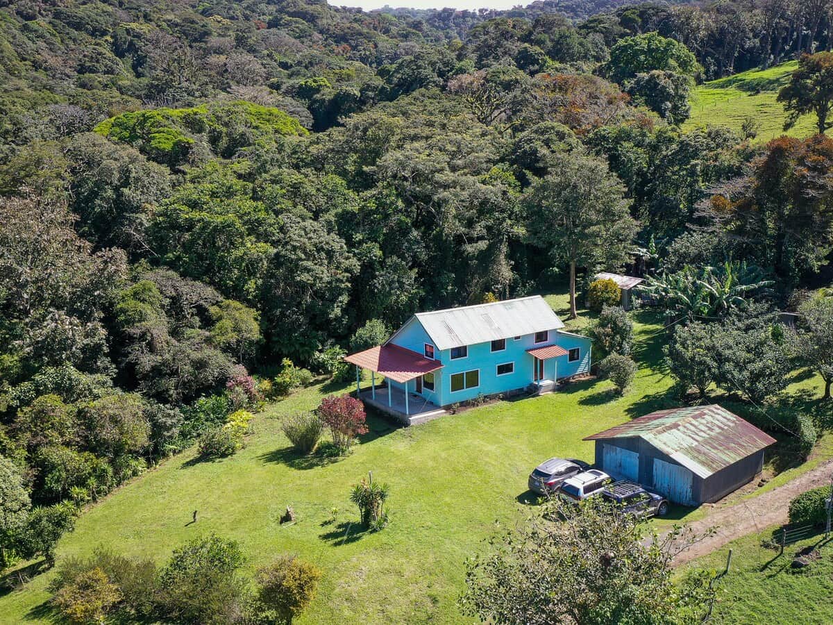 Exterior view of the property with spacious grounds and a peaceful natural setting.