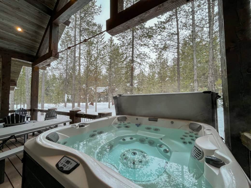 8 person hot tub located on the deck with a view of the woods and wildlife 