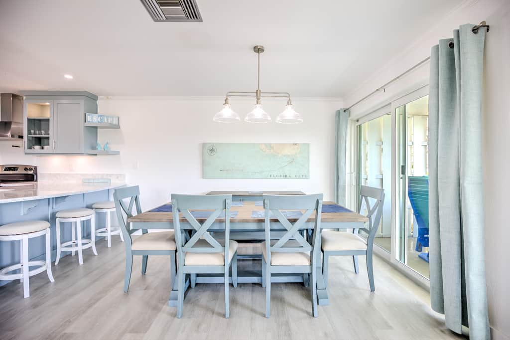 The dining table sits by the balcony sliders for easy breakfasts and long dinners.