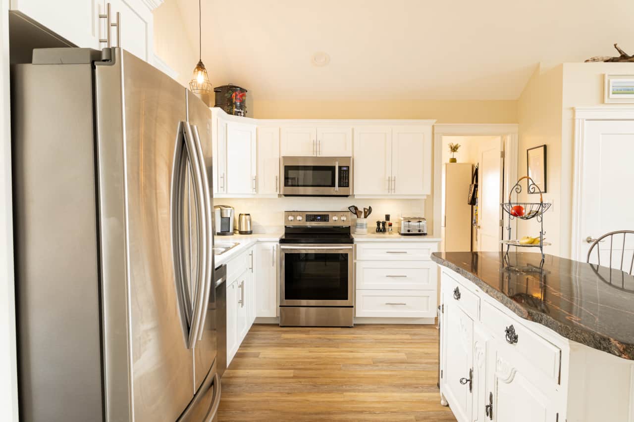 Kitchen with stainless steel range, microwave and plenty of counter space