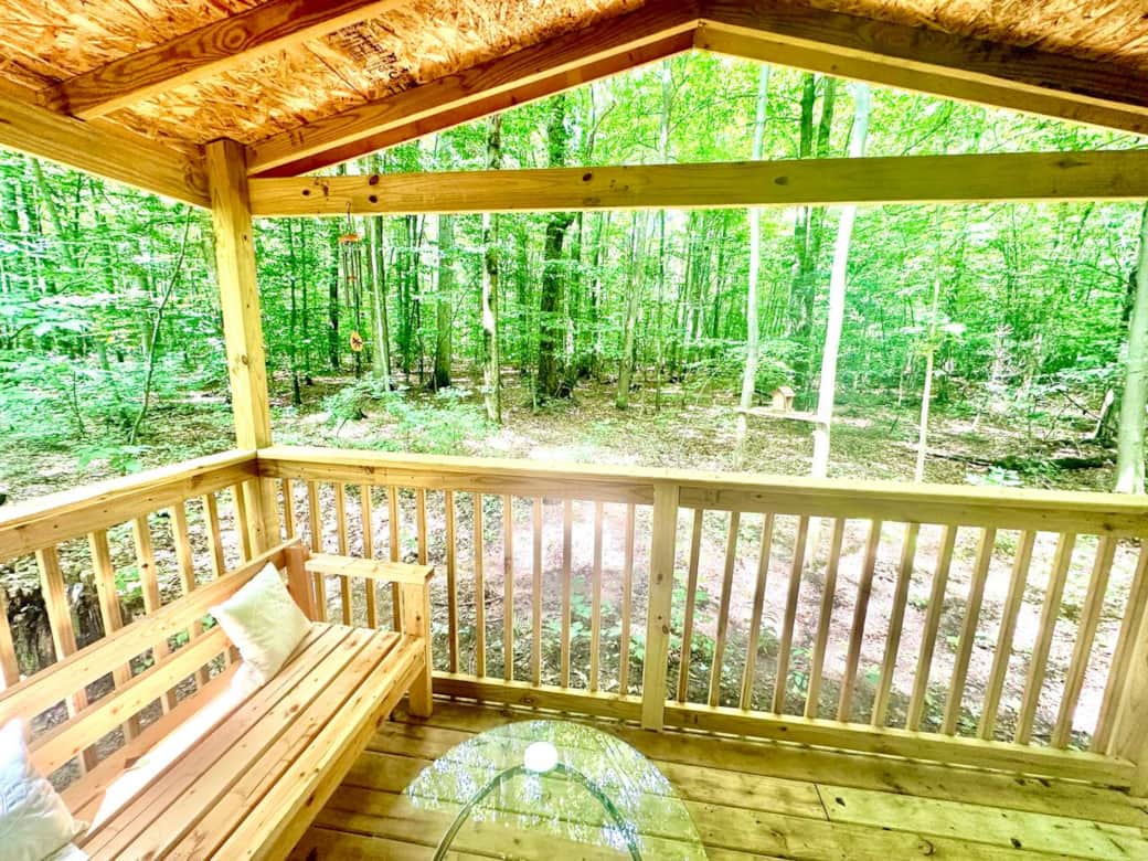 This picturesque porch offers a front-row seat to nature's theater. Surrounded by a choir of towering trees this view truly provides an idyllic panorama of the ever-changing, yet always beautiful, woodland canvas.