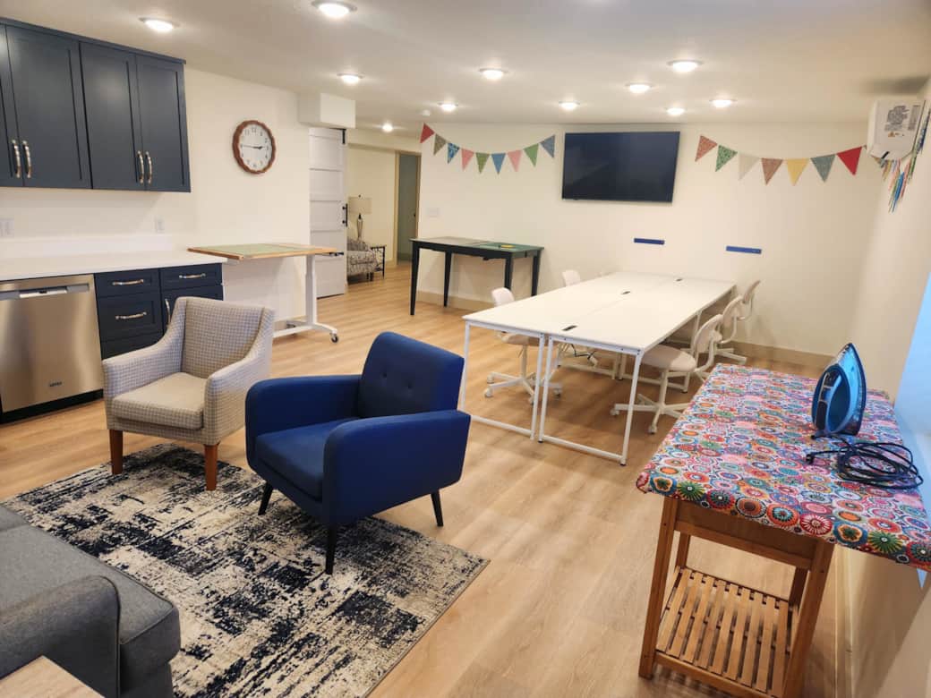 Sewing studio for six has two cutting tables, two ironing stations, and comfortable sewing chairs. Sewing studio for six has two cutting tables, two ironing stations, and comfortable sewing chairs.