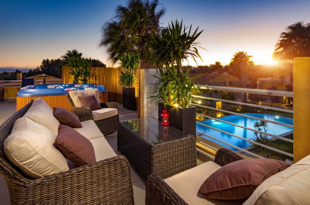 Enjoy sunset drinks with rooftop views overlooking the pool and palm trees Enjoy sunset drinks with rooftop views overlooking the pool and palm trees