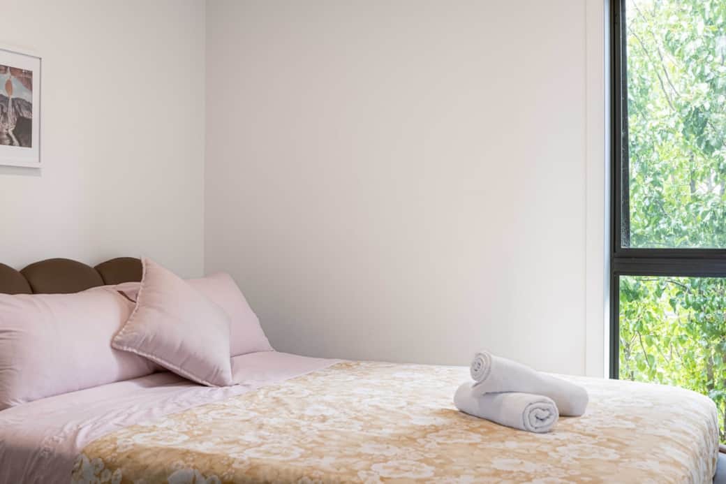 Step into our simple and clean guest room, a perfect sanctuary for travelers. The minimalist design ensures a clutter-free environment, promoting relaxation. The comfortable bed, paired with crisp linens, guarantees a good night's sleep.
