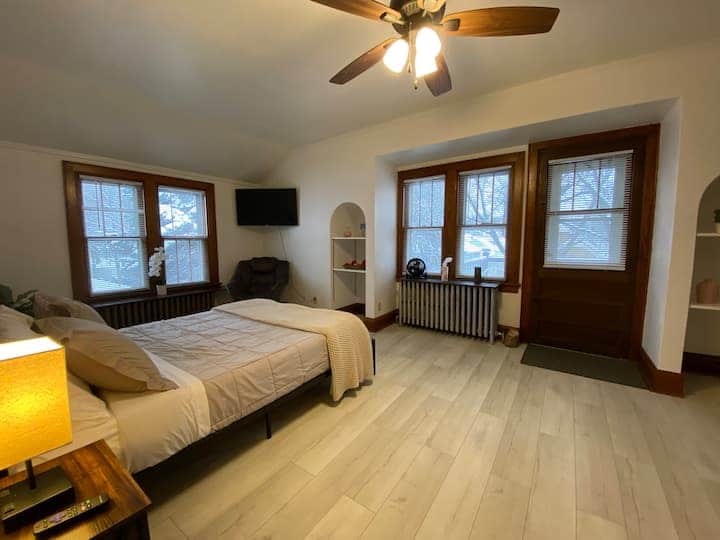 Bright and inviting private bedroom with warm natural light and classic charm.