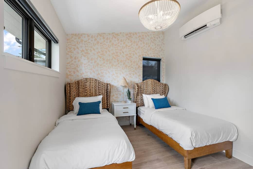 Seagrass headboards on twin beds with hand painted wall mural