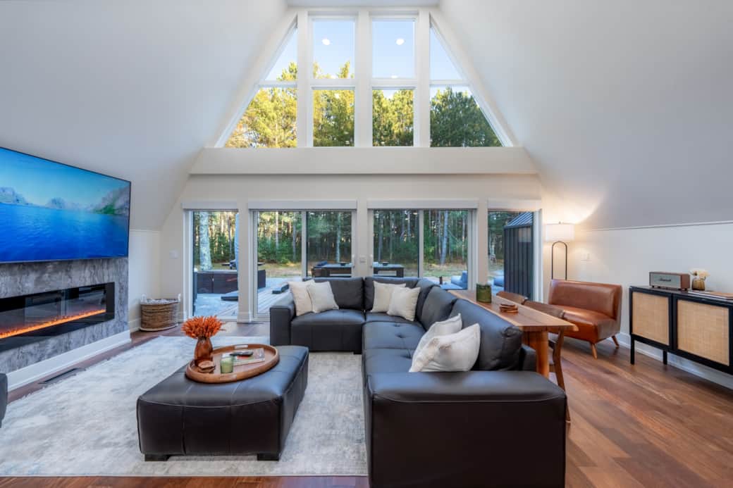 Window wall with electric fireplace, comfortable seating, and more.