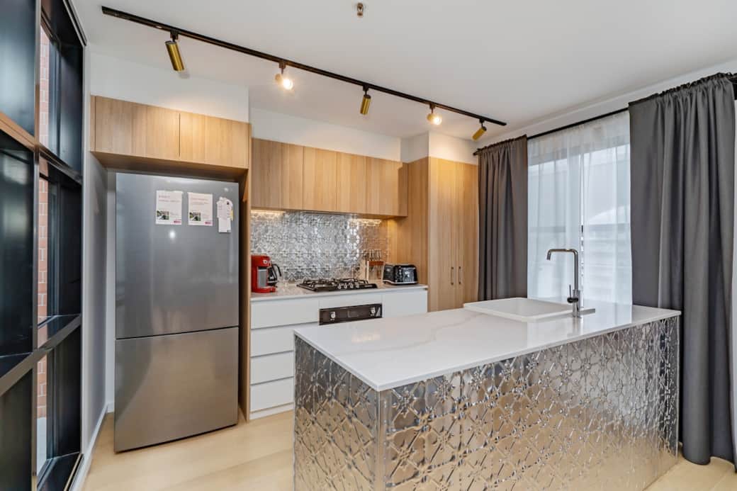 Impress your culinary skills in our gourmet kitchen, equipped with modern appliances and a spacious island. The sleek design and ample counter space make cooking a pleasure. The large windows bring in natural light, creating a bright atmosphere. 