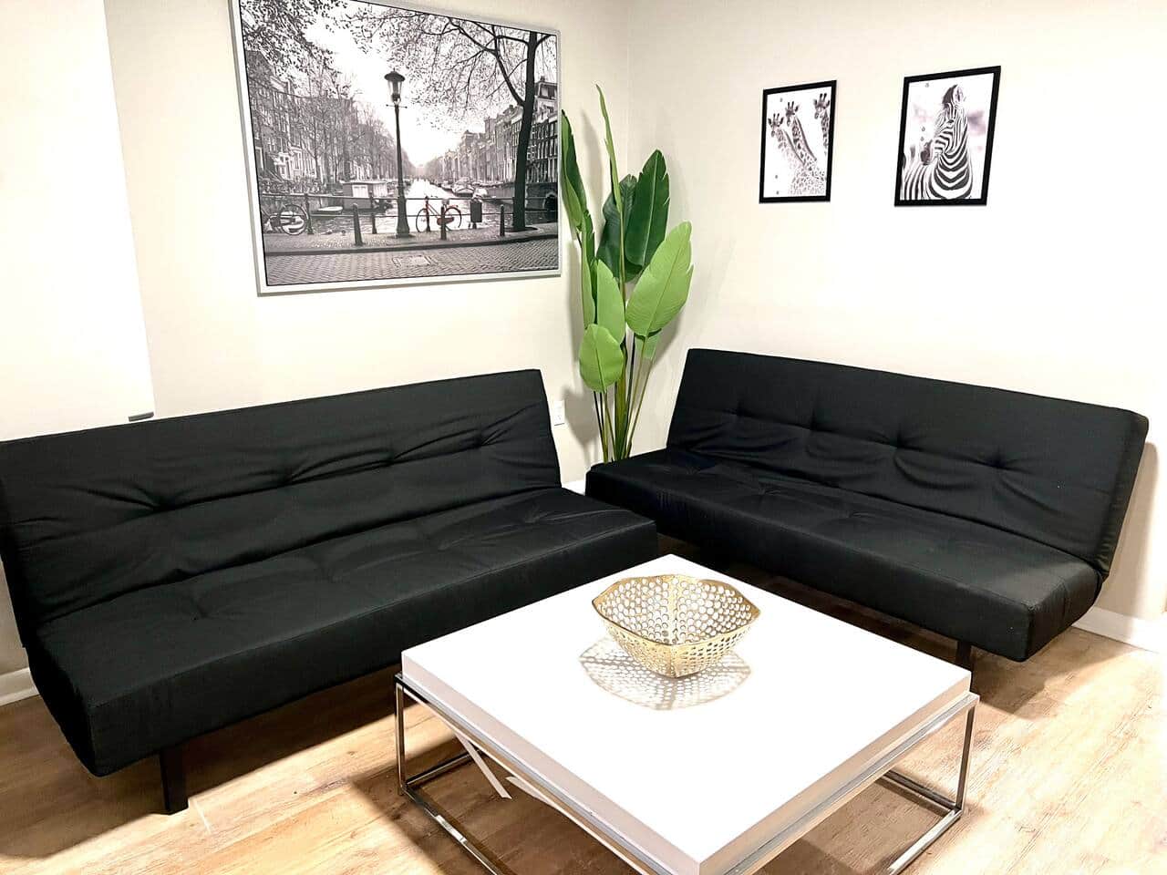 The living room features two comfortable futon sofa beds, perfect for relaxing or accommodating extra guests. Fast WiFi, 55 inch flat-screen TV, equipped with a variety of Roku channels, and an electric fireplace..
