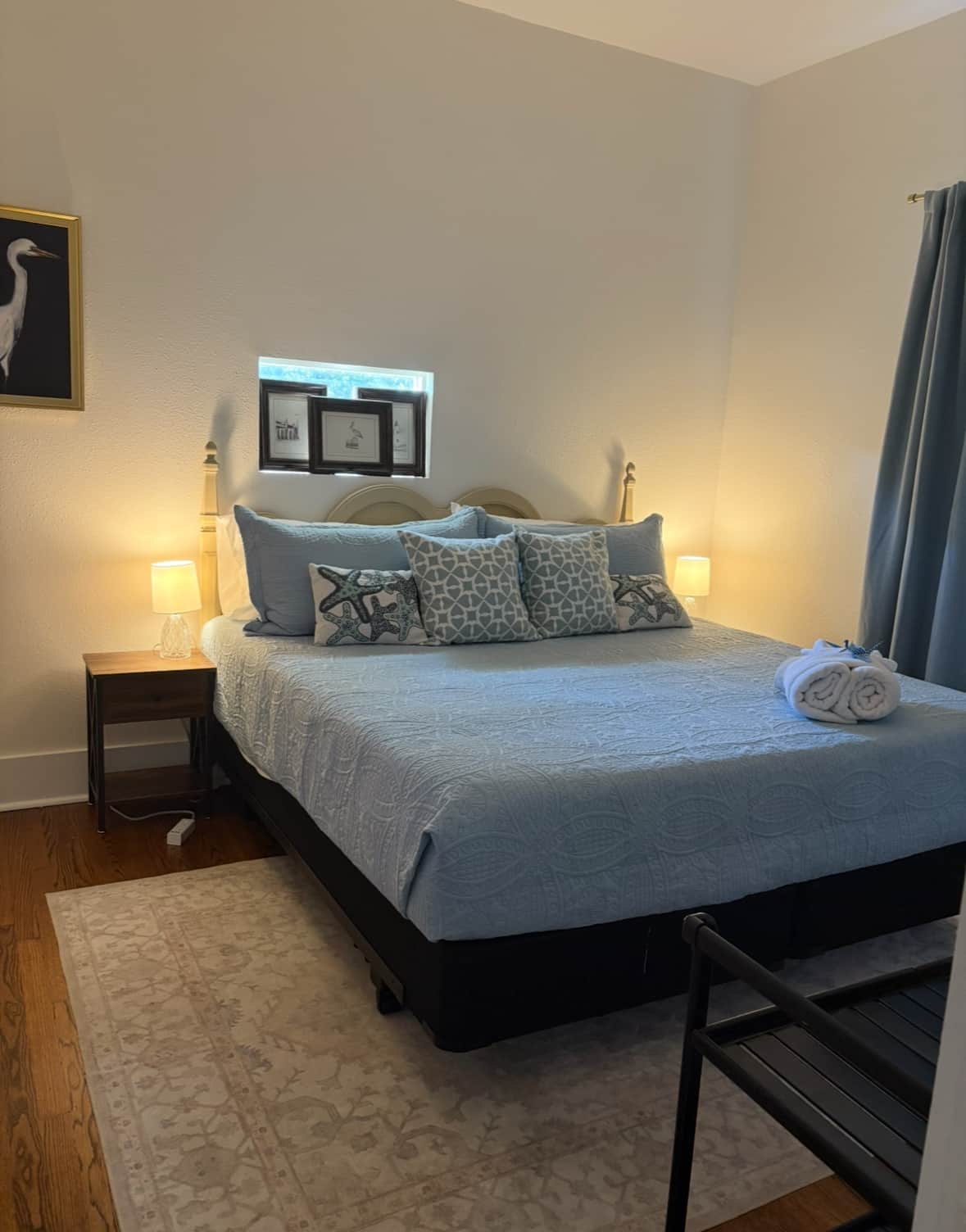 King bed with crisp linens in a coastal-style bedroom at a luxury Galveston vacation rental
