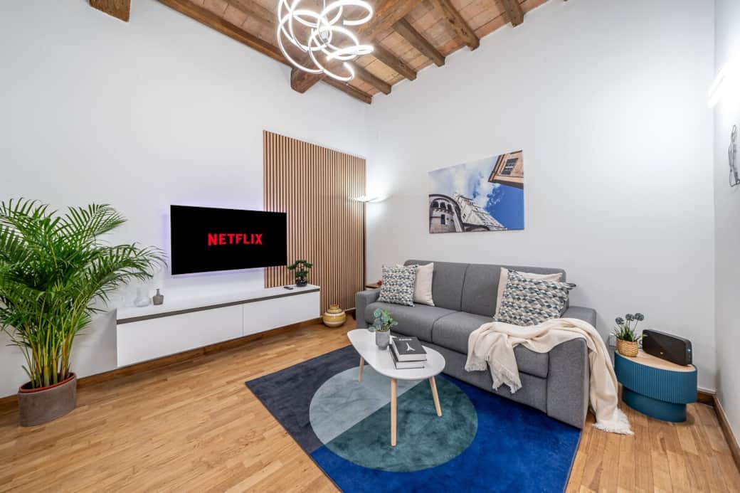 Spacious living area featuring a comfortable double sofa bed, flat-screen TV, and ultra-fast broadband — ideal for both families and business travelers.