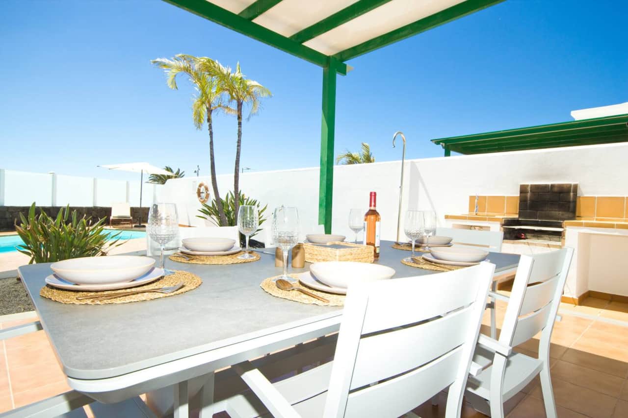 Outdoor dining area overlooking the private pool at an AZ Rentals holiday villa