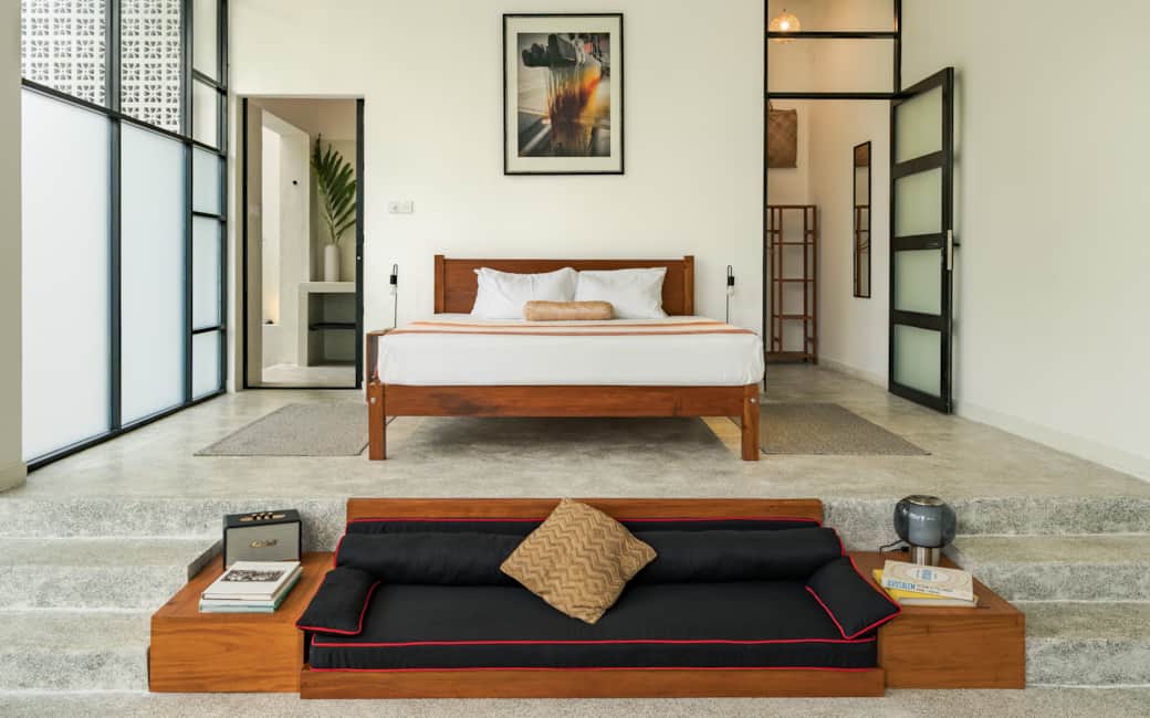 From the kitchen, looking across to the bed and the daybed sunk into the floor.