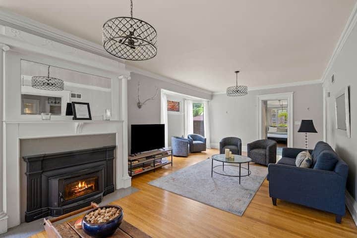 Bright and inviting living room with a cozy fireplace, plush seating, and plenty of natural light.