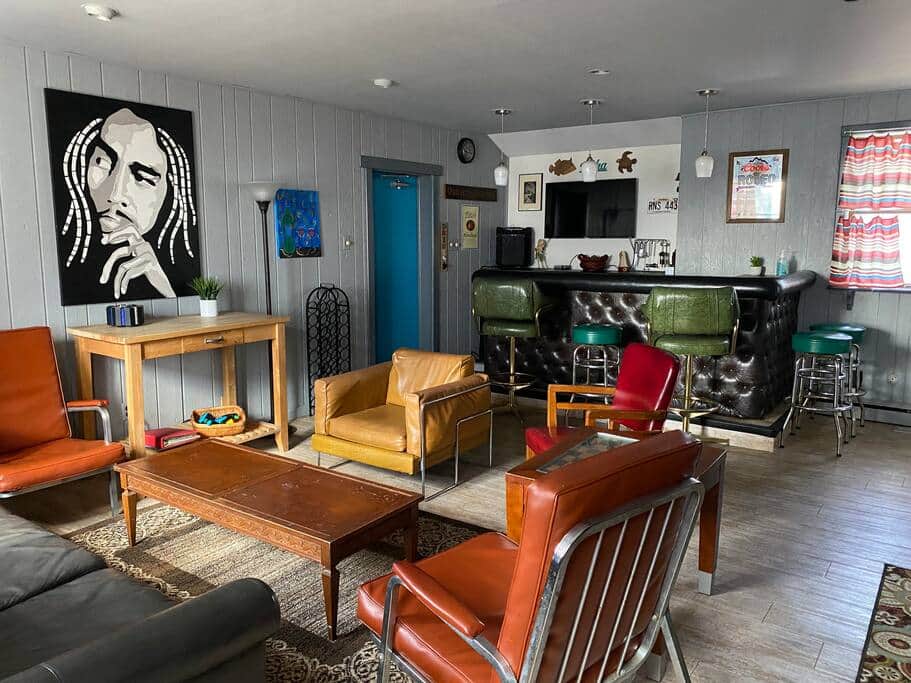 Bar with mini fridge, TV, Foosball and washer and dryer in utility closet.