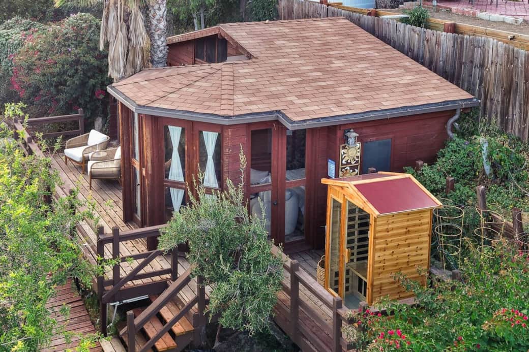 Aerial view of the full property showcasing the home, deck, and surroundings. Aerial view of the full property showcasing the home, deck, and surroundings.