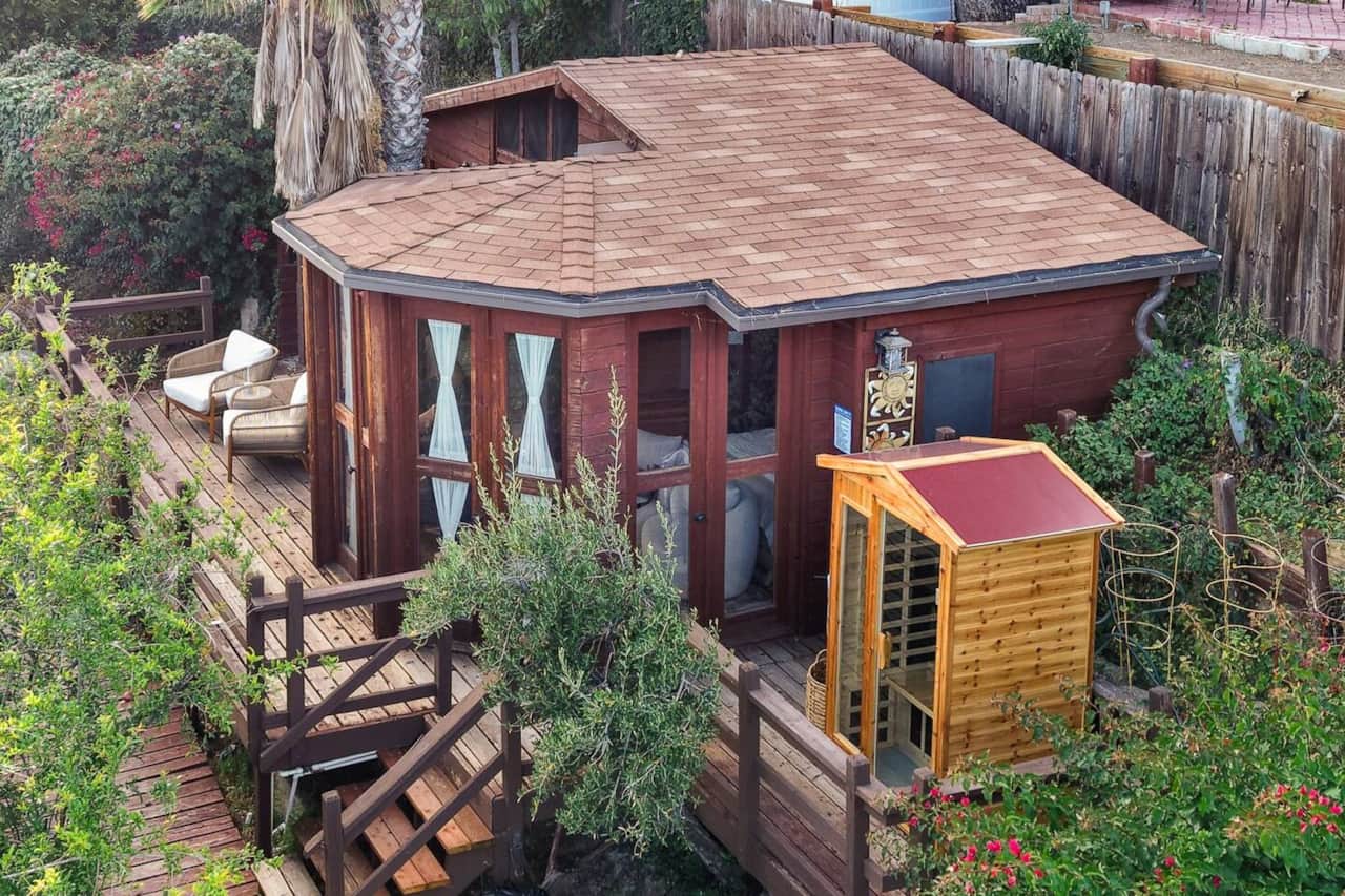 Aerial view of the full property showcasing the home, deck, and surroundings.