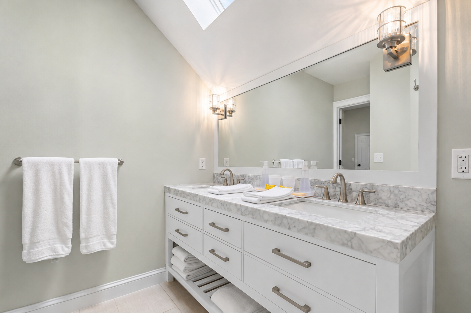 Get ready side by side at the double vanity, with fresh towels and extra linens within easy reach.