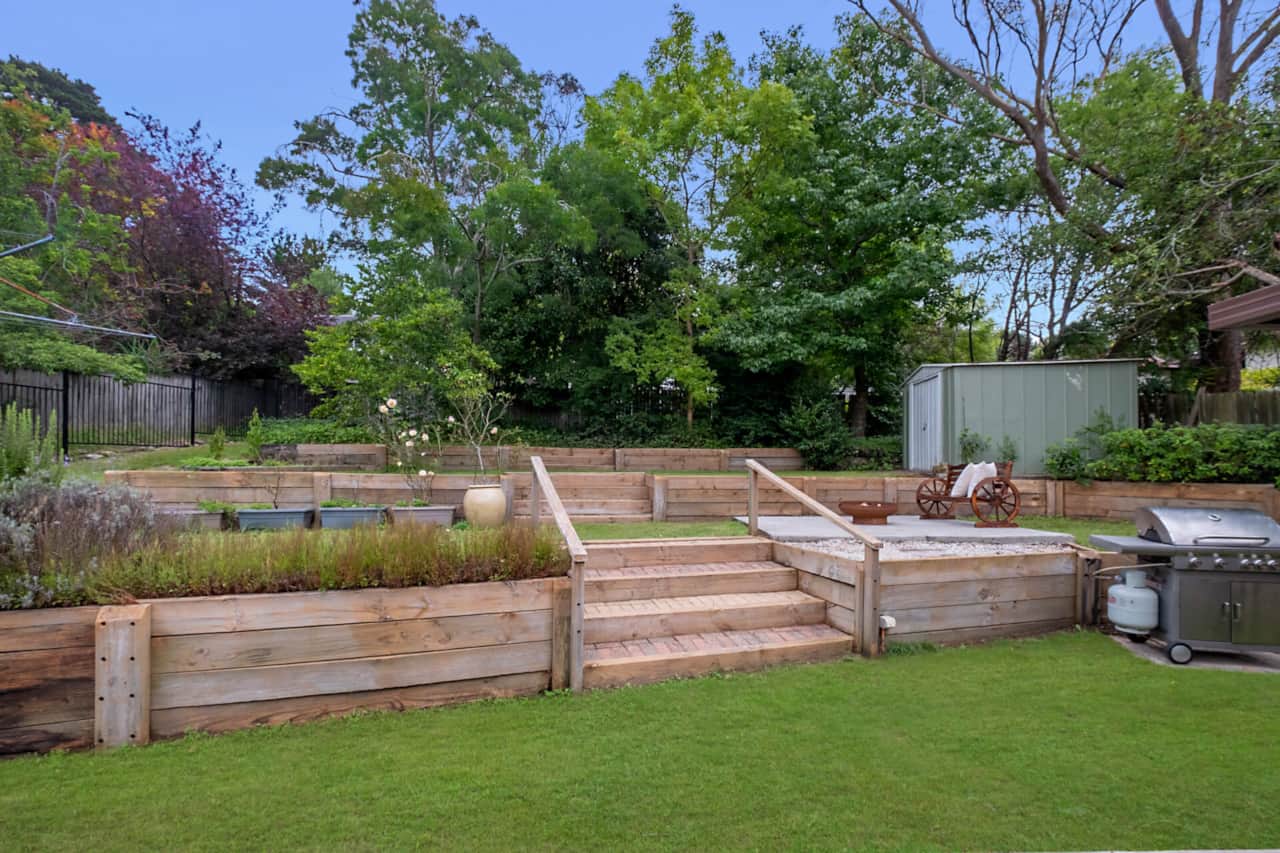 Terraced back garden with patio seating area, gas BBQ and firepit, to relax and entertain.