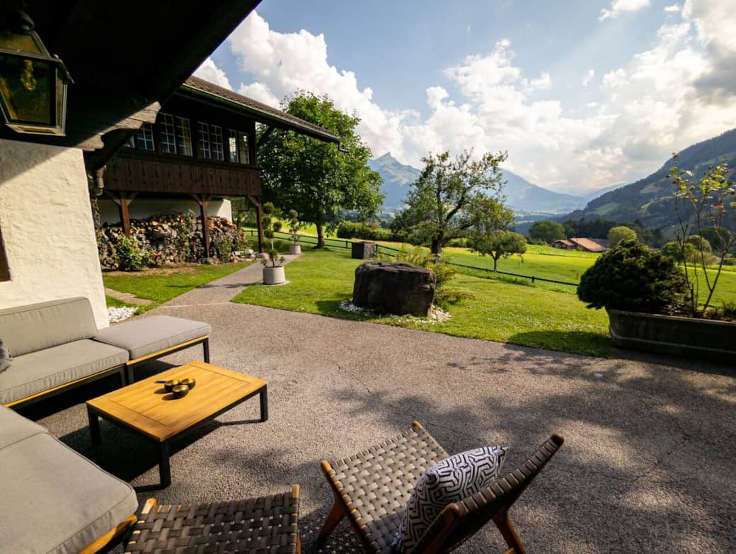 Our outdoor space features a spacious covered terrace, protected from the elements, complete with comfortable lounge seating, a granite dining table, a barbecue grill, and extra sun covers.