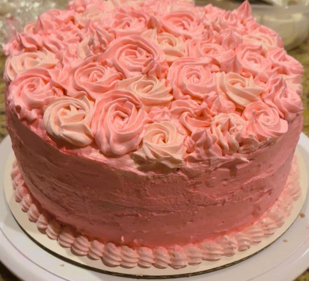 Custom pink birthday cake prepared for a guest at White Magnolia Galveston