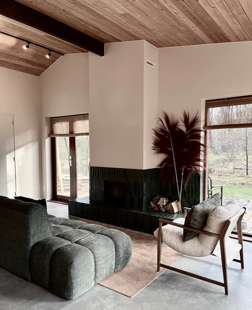 Living area with fireplace and forest views
