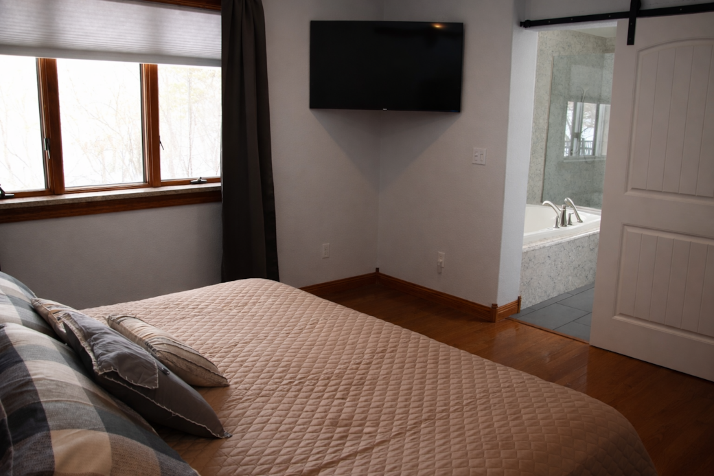 Primary suite with ensuite bath and Roku TV. Primary suite with ensuite bath and Roku TV.