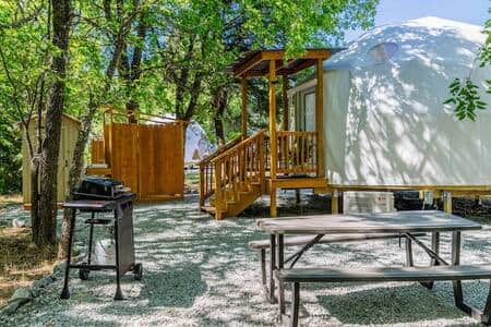 Picnic table, gas BBQ stove, outhouse and outdoor shower