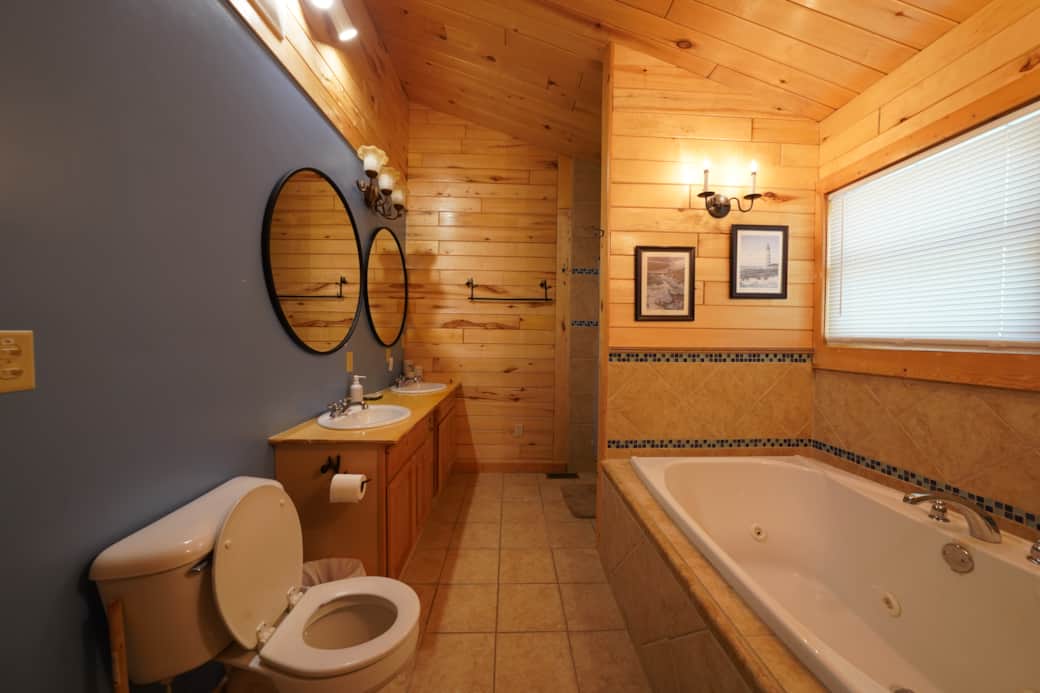 Master bathroom with double vanity and jetted bathtub. 
