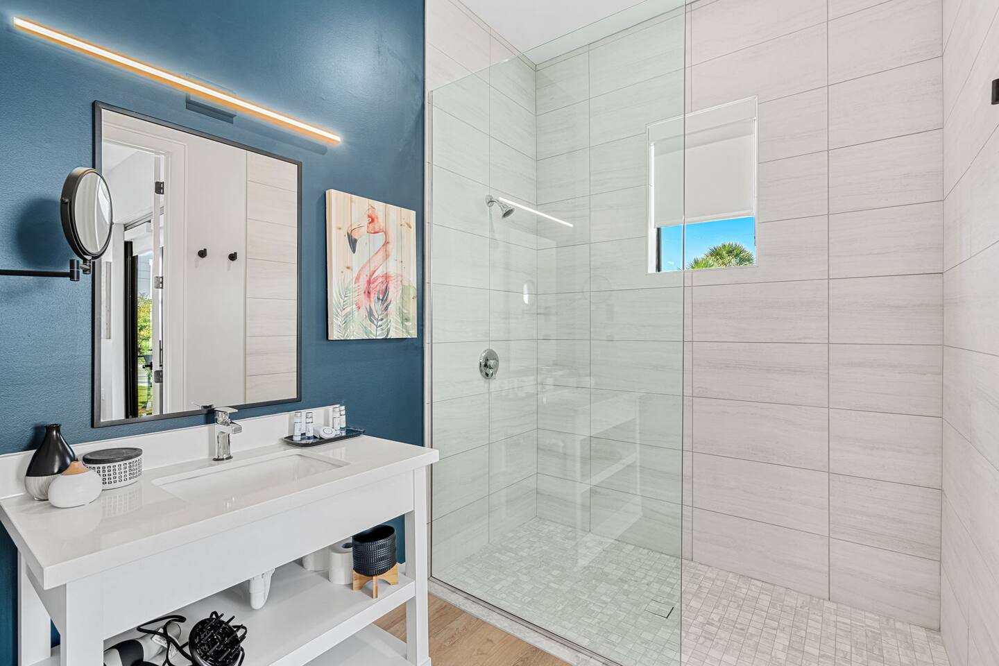 Step into a spacious walk-in shower with natural light streaming through the window.