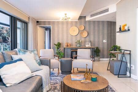 A stylish and spacious living room with modern furnishings and abundant natural light. A stylish and spacious living room with modern furnishings and abundant natural light.