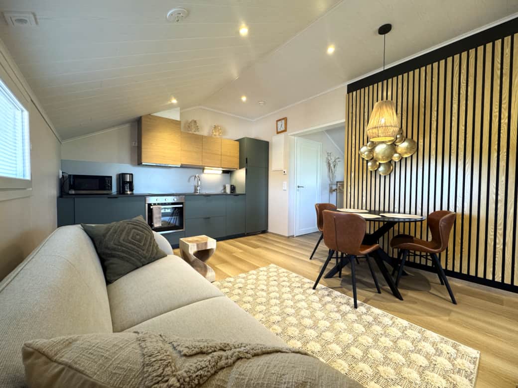 An apartment on the second floor with a sofa, TV, dining area, and a well-equipped kitchen. An apartment on the second floor with a sofa, TV, dining area, and a well-equipped kitchen.