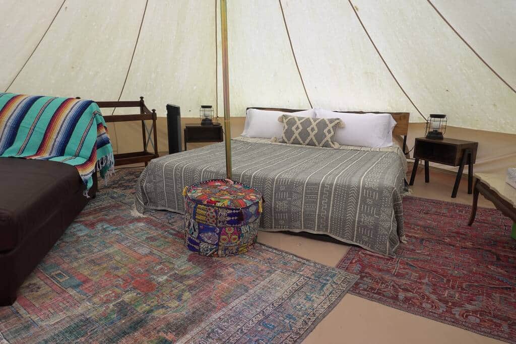 Inside yurt with side tables and seating