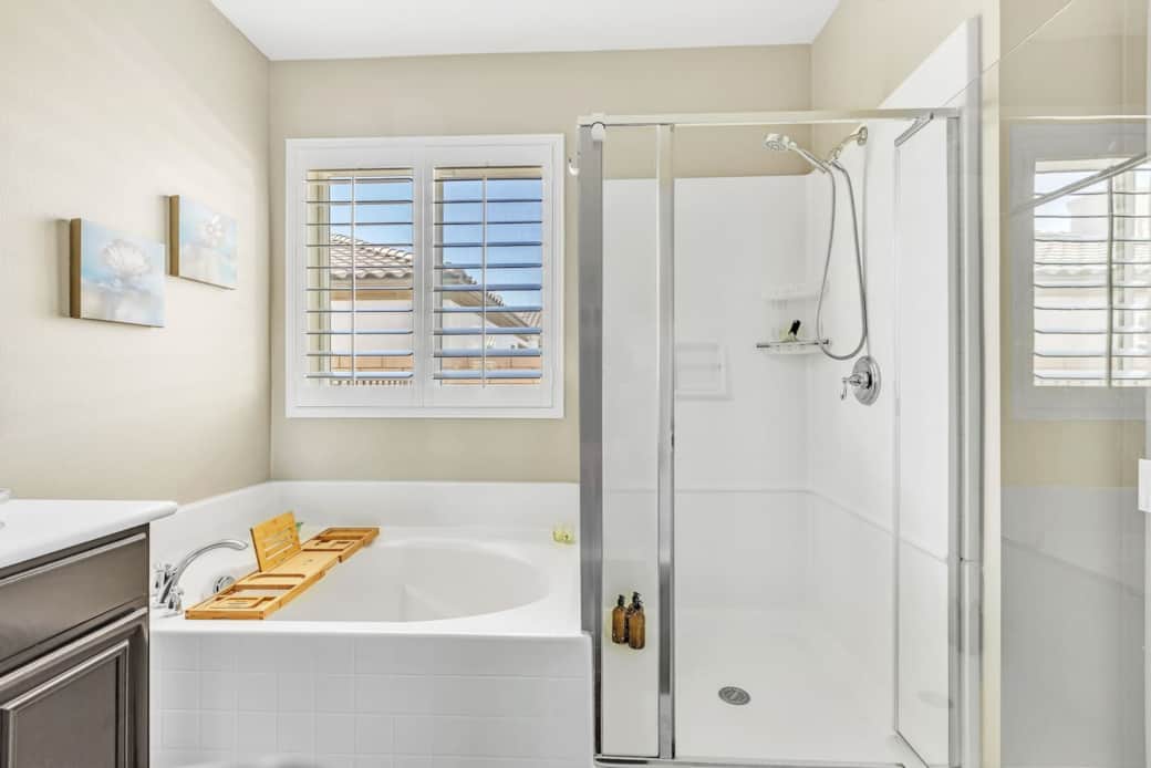 Ensuite bathroom with walk-in shower, soaking tub, and bright windows.