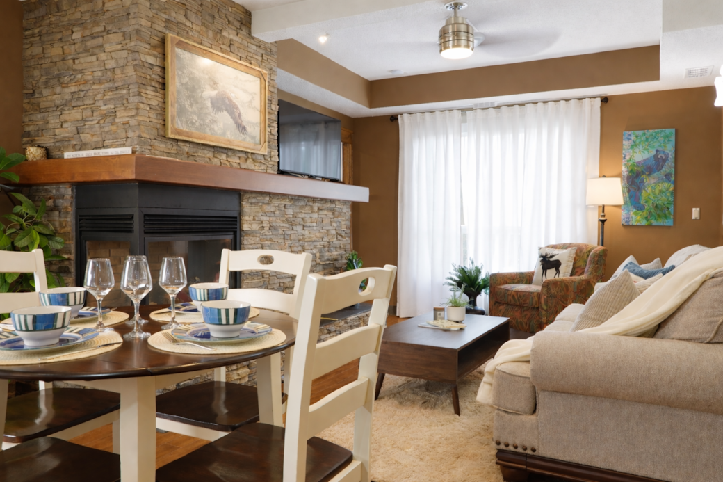 Dining and living space with a bedroom and bathroom on either side.