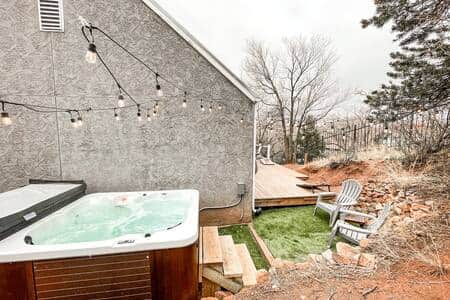 Private hot tub with string lights for evening enjoyment.