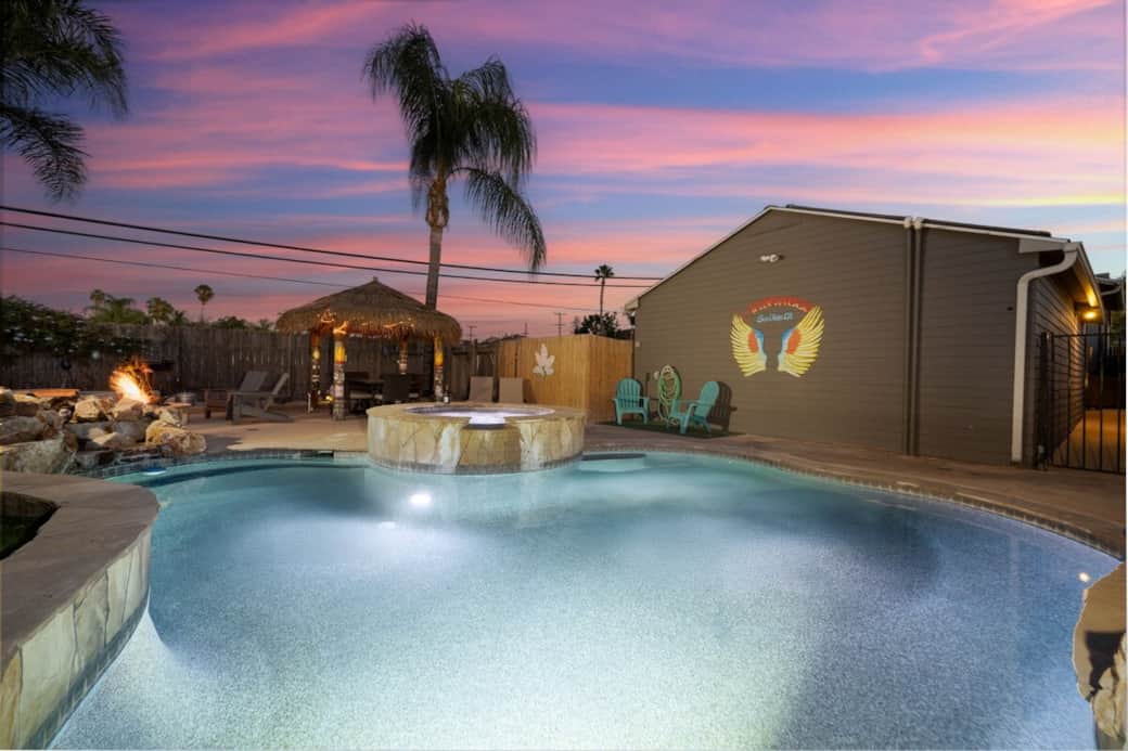 Relax in your private backyard oasis with a sparkling pool, spa, fire pit, and tropical cabana. Perfect for sunset swims, outdoor dining, and peaceful evenings under the palm trees at The Birdhouse SD. Relax in your private backyard oasis with a sparkling pool, spa, fire pit, and tropical cabana. Perfect for sunset swims, outdoor dining, and peaceful evenings under the palm trees at The Birdhouse SD.