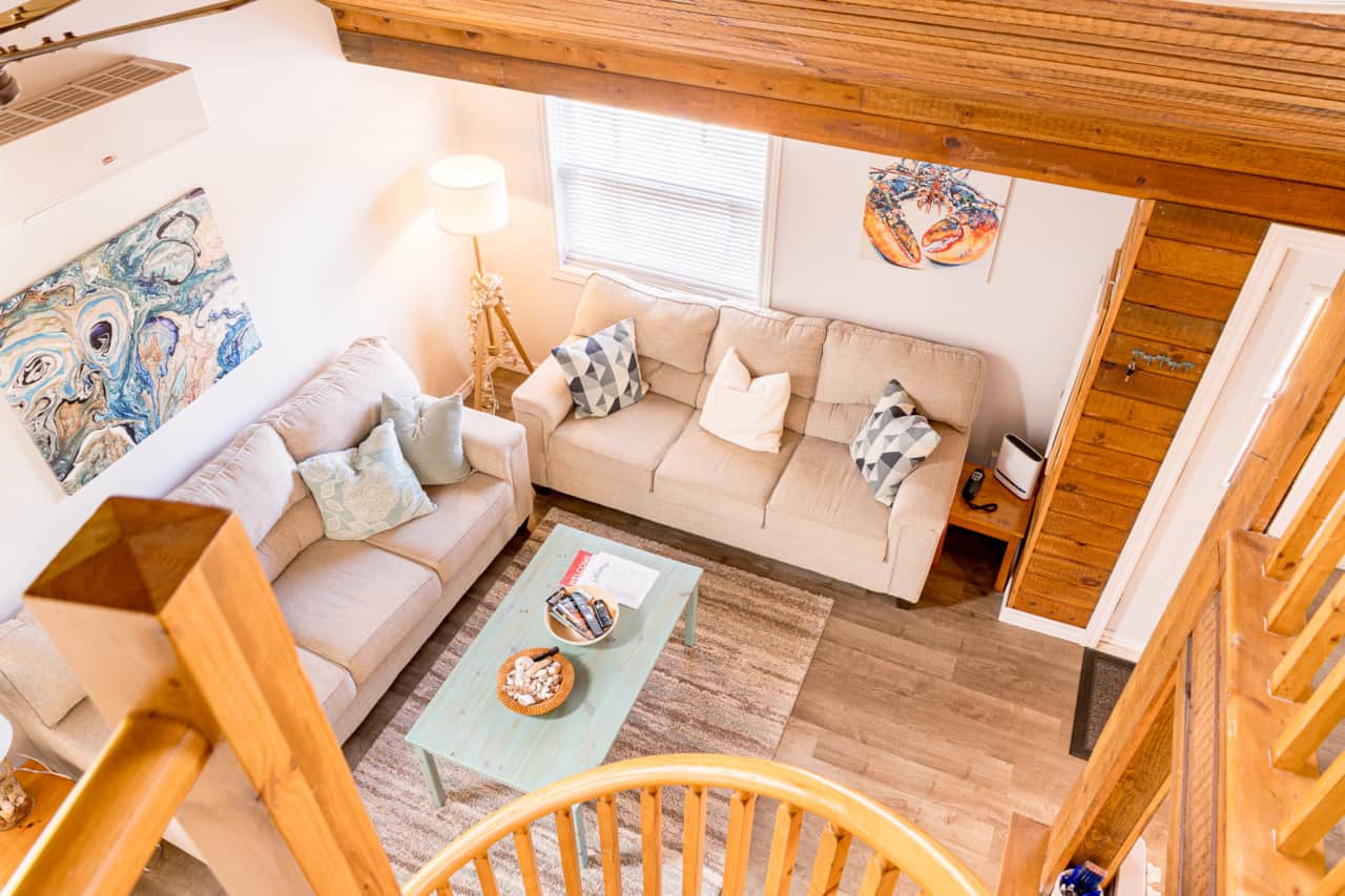 Living room viewed from the loft, with coastal decor