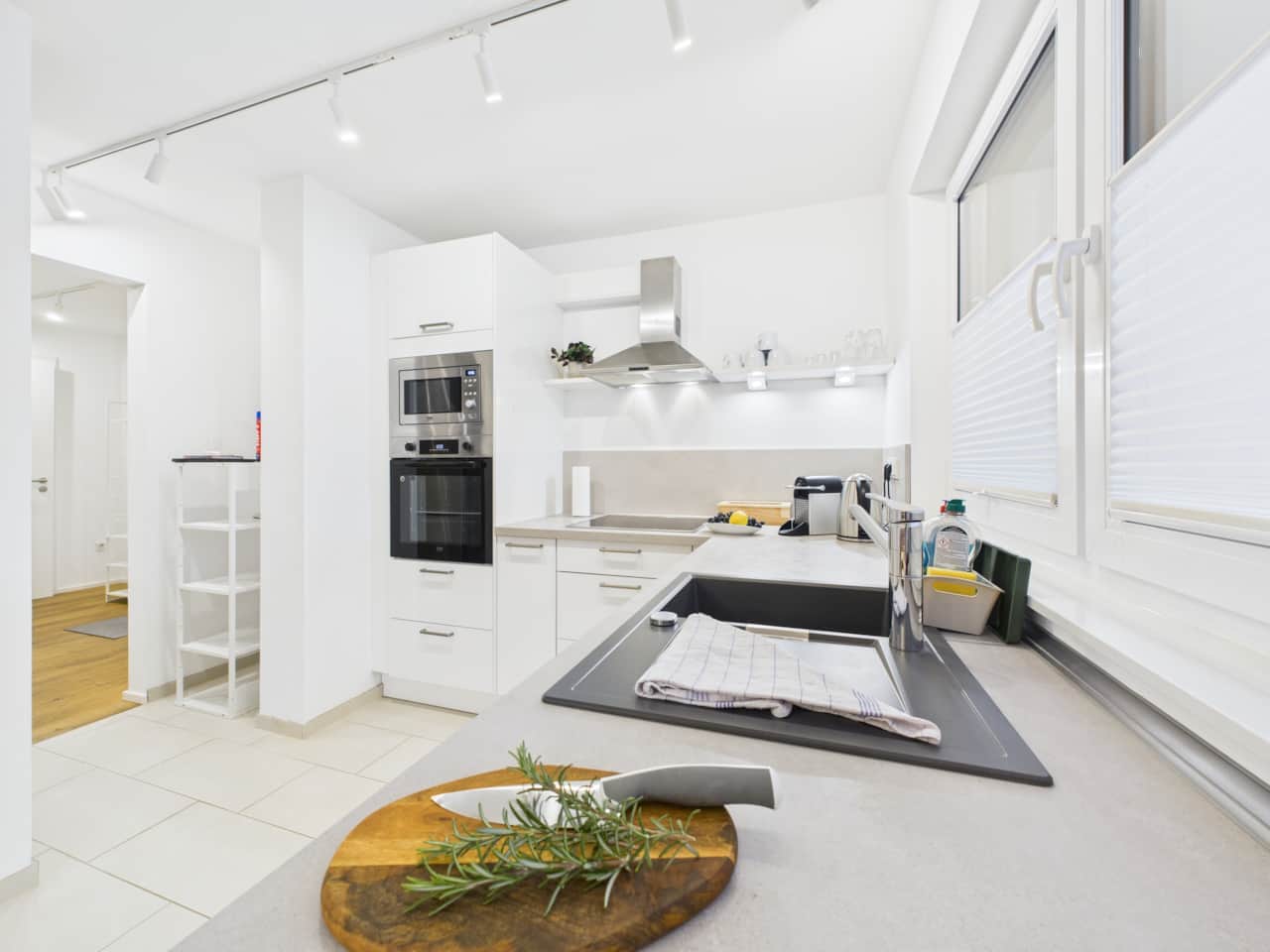 Modern, bright, fully equipped kitchen with oven, microwave, and plenty of counter space.