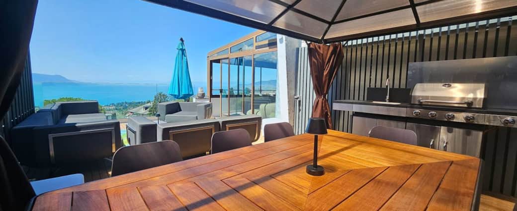 Ground-floor terrace with kitchen, BBQ, and pergola. Views of the mountains and Lake Geneva.