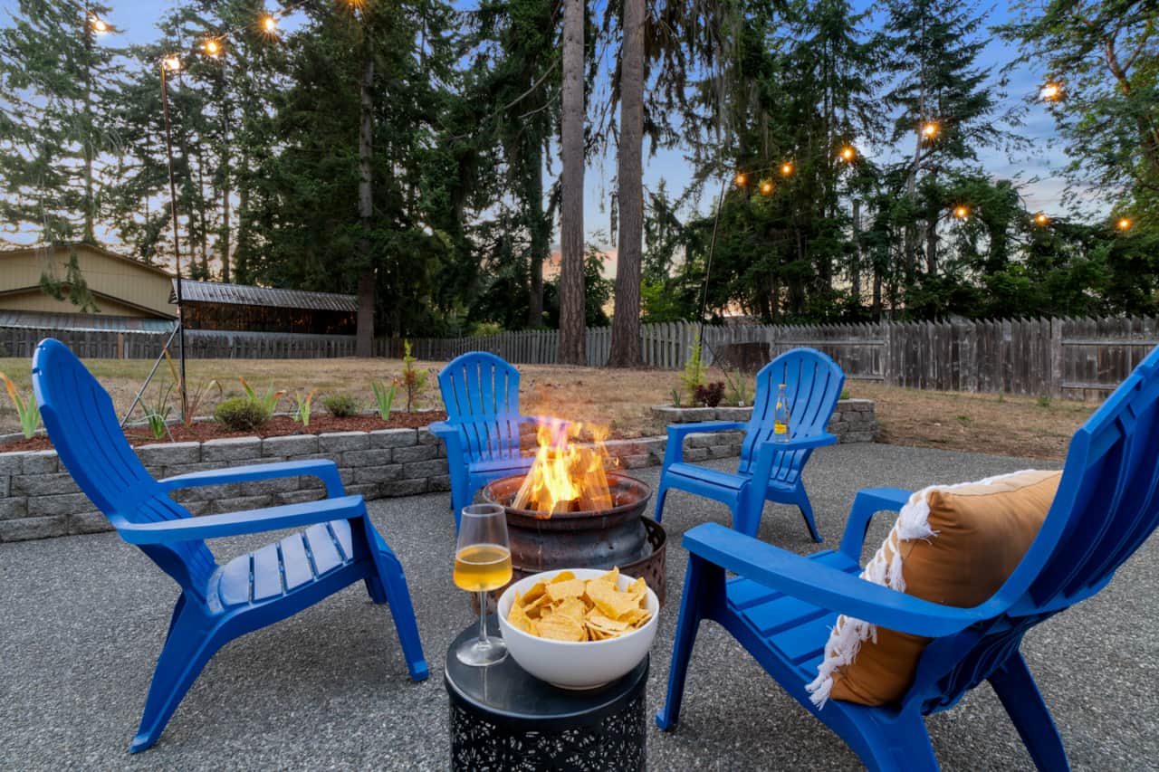 Large fully fenced backyard with tall trees