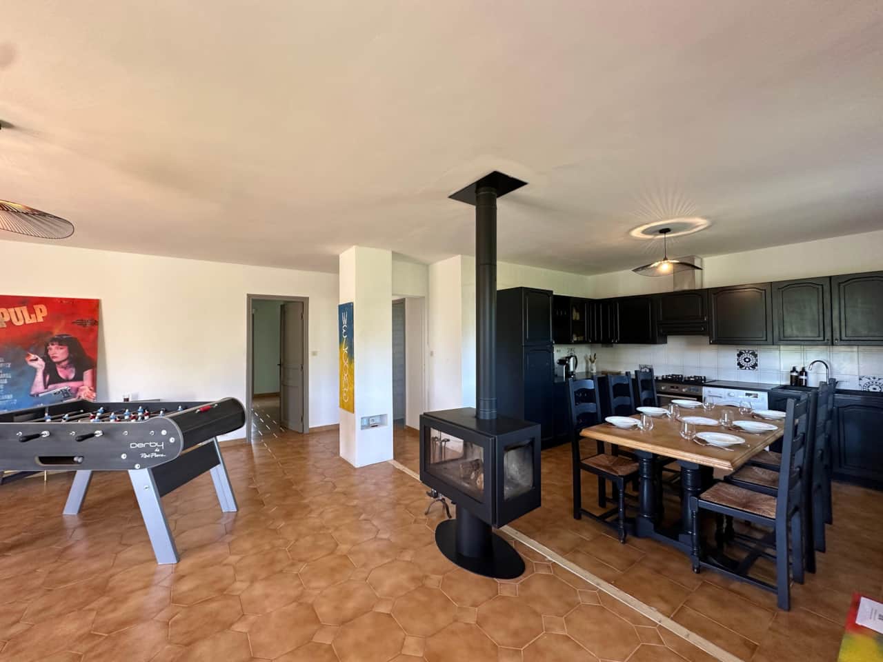 kitchen, fireplace, foosball, dining table, chairs