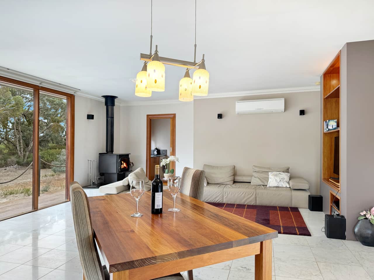 Enjoy comfort in the living room with AC and a cozy fire, designed for your relaxation.