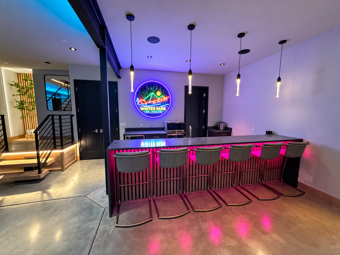 Lower-level bar with colorful accent lighting.