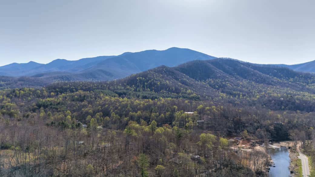 22 private acres with trails leading through forest and riverfront.