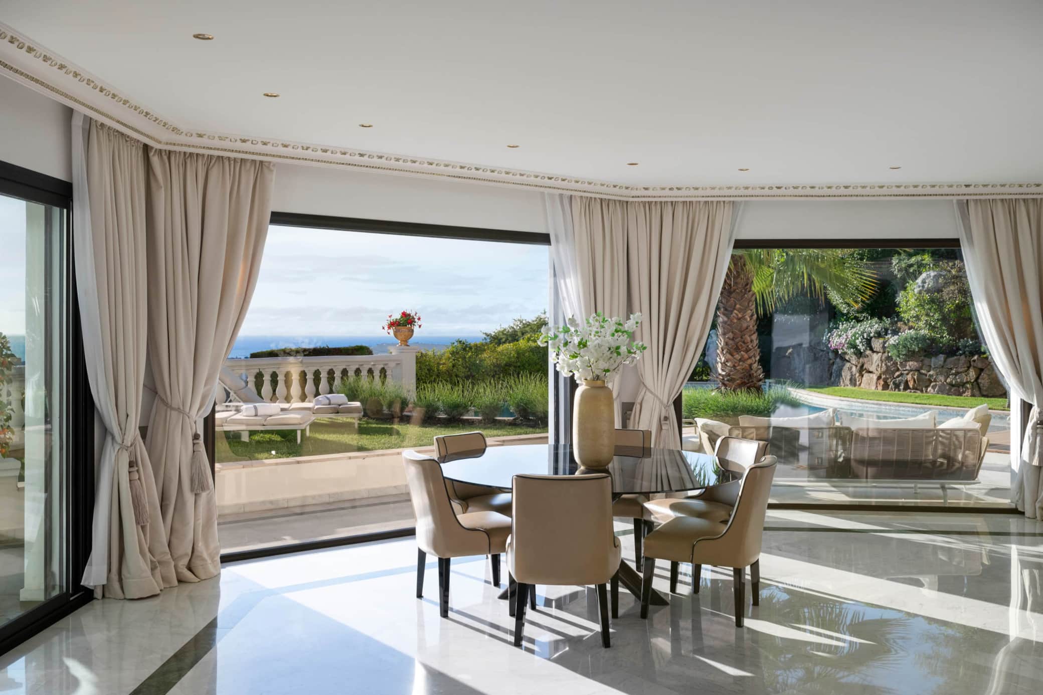 Dining area with panoramic windows overlooking the sea