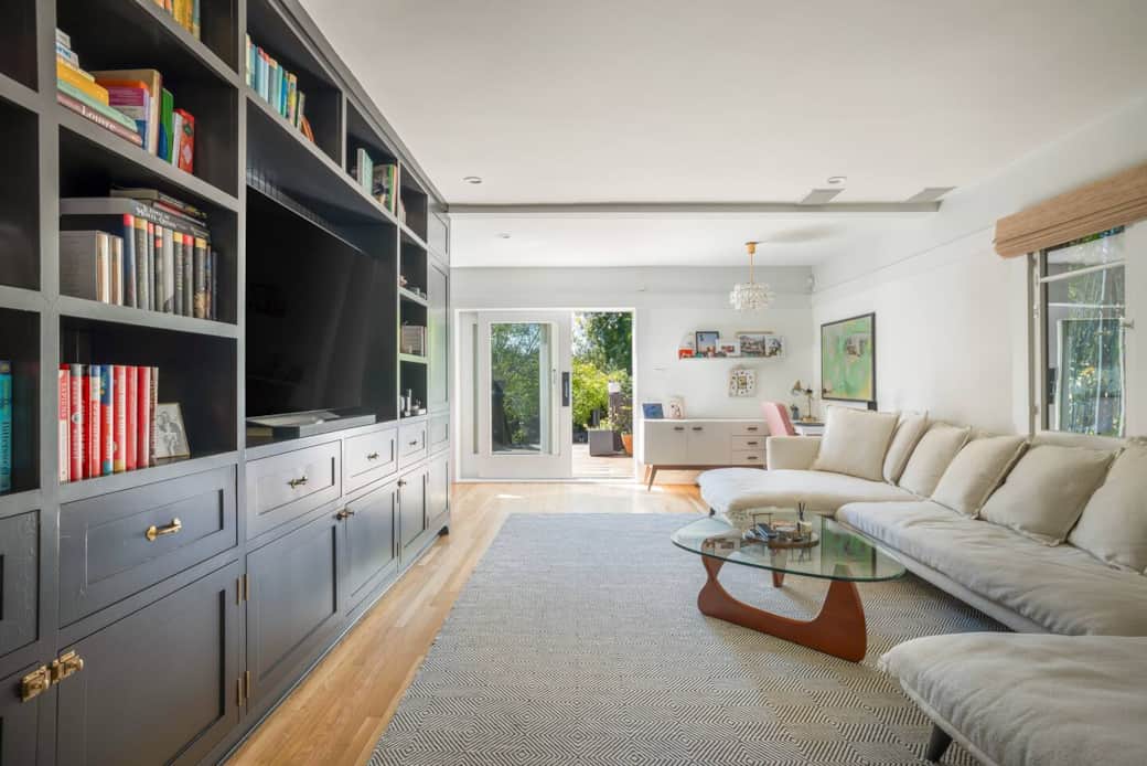 Smart built-in shelves frame an Apple TV and desk—the perfect spot to work, stream, or relax.