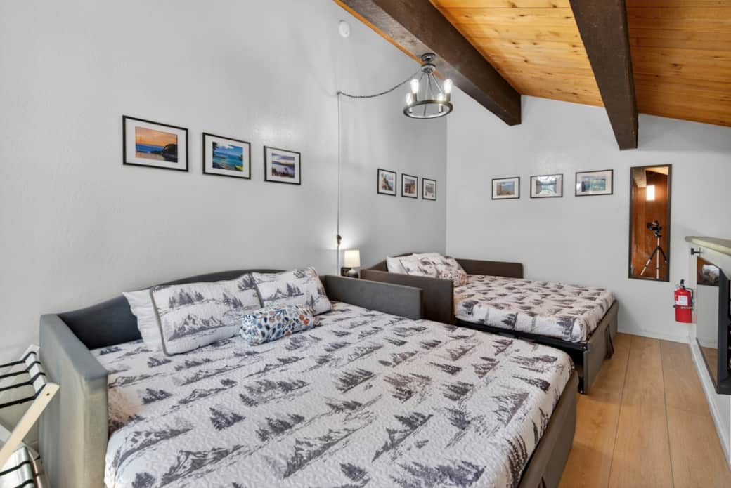 Second loft-style bedroom w/ TV. The day beds can be 2 single beds or 4 single beds (trundle) or 2 kings beds. 