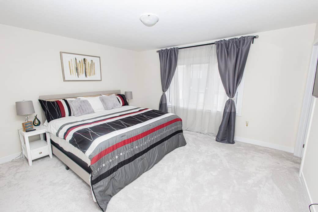 Master Bedroom w/ensuite, large walk-in closet TV and mini fridge